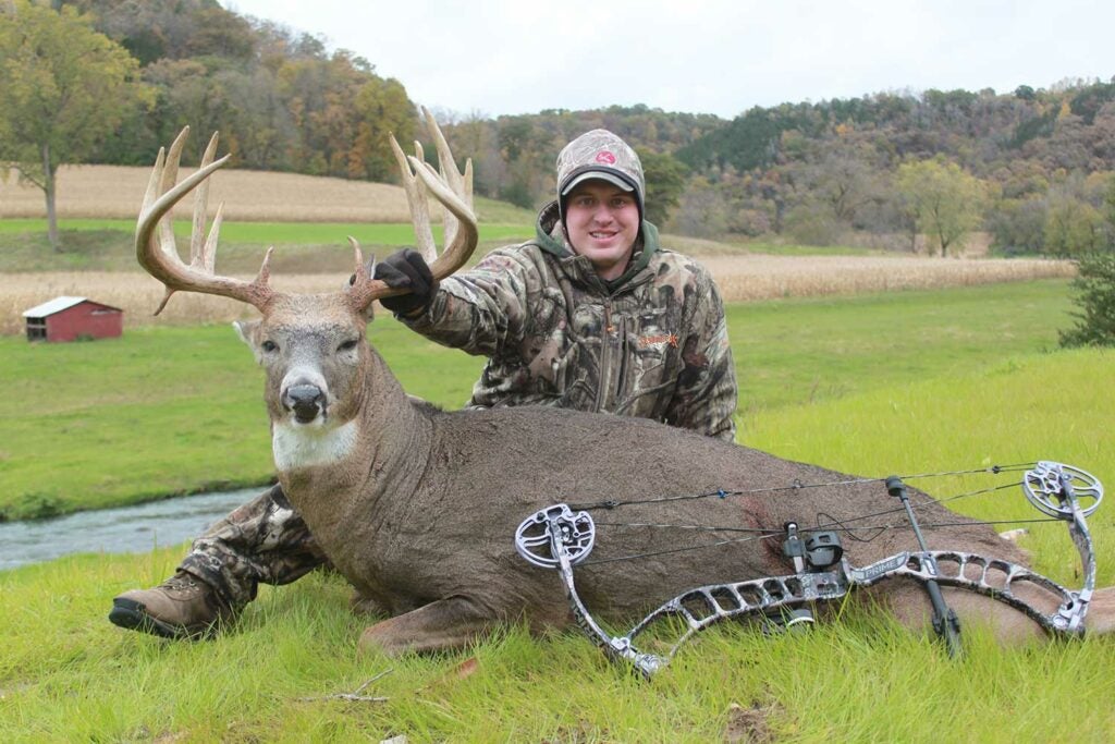 hunter with a whitetail buck