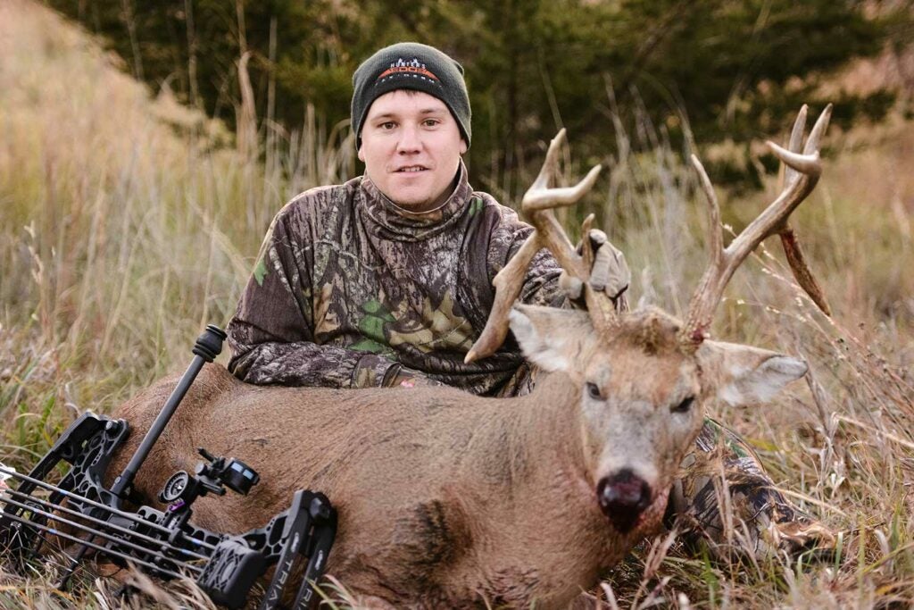 hunter with a drop-tine buck