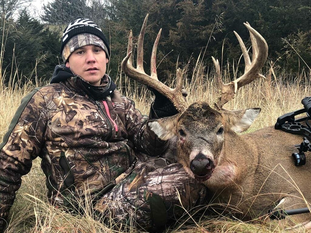 hunter posing with a whitetail buck.