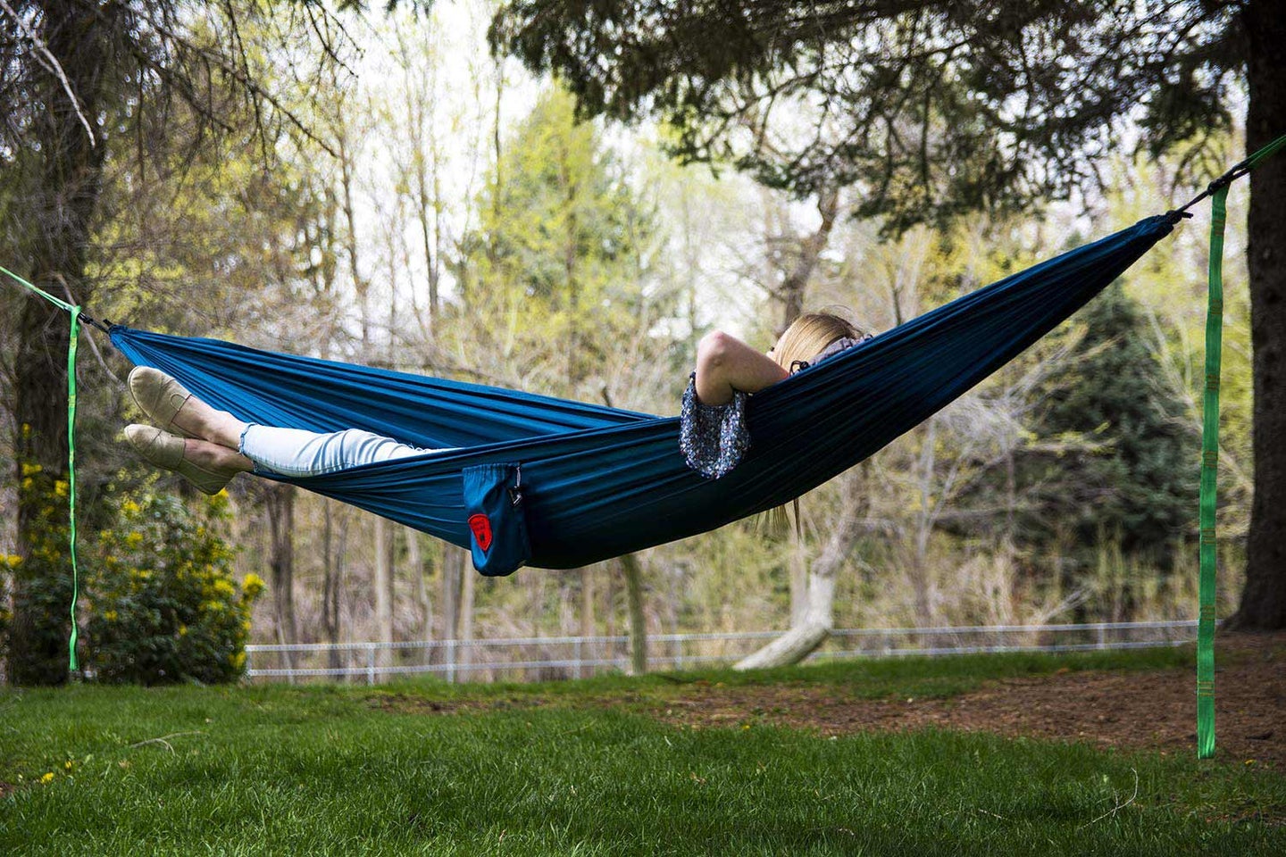 a woman laying in a hammock.
