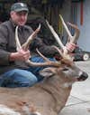 hunter with a 9-point trophy buck