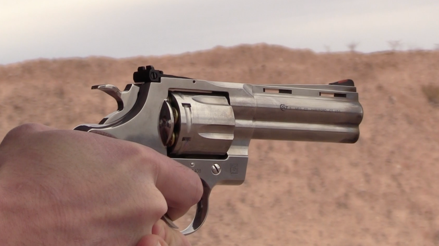 shooting a Colt Python, in hand, at the range
