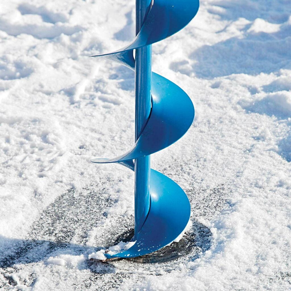 An ice auger drilling a hole in the ice.