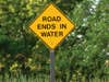 A road ends in water sign.