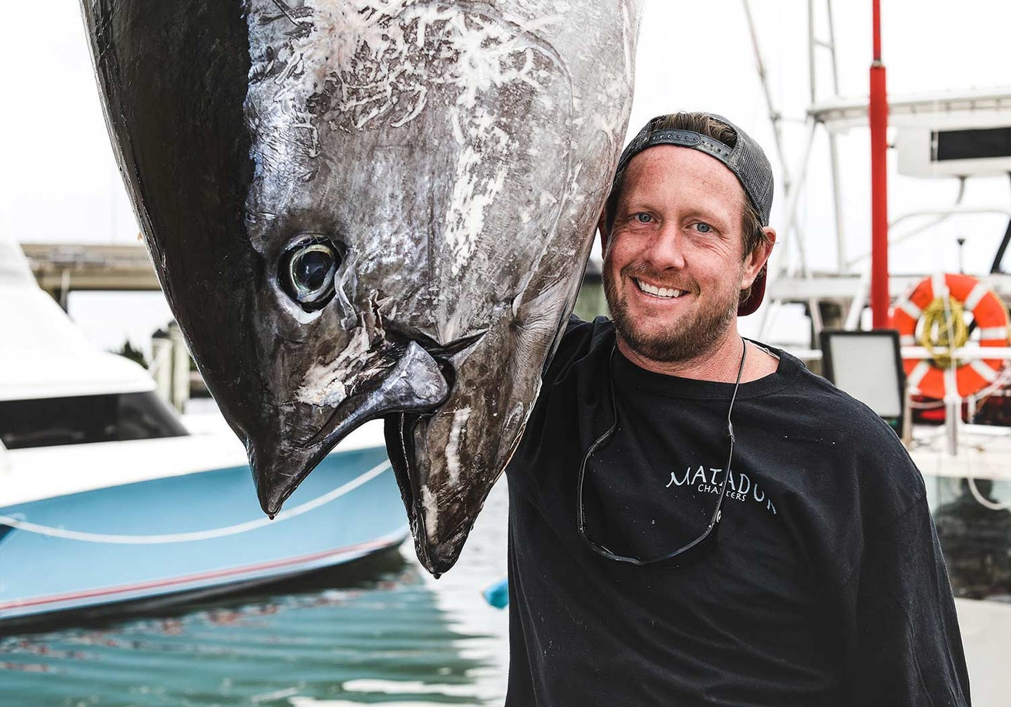 Captain Jake Hiles and 708-pound tuna that is the pending new state Virginia record.