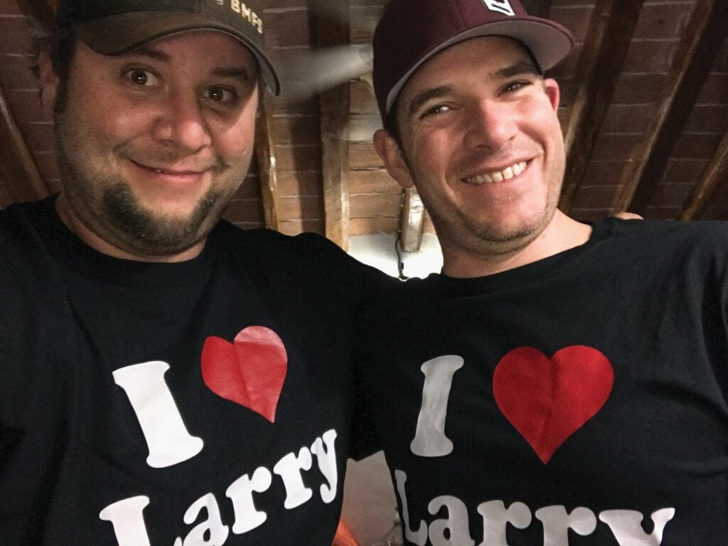 Two men wearing an I Love Larry shirt.