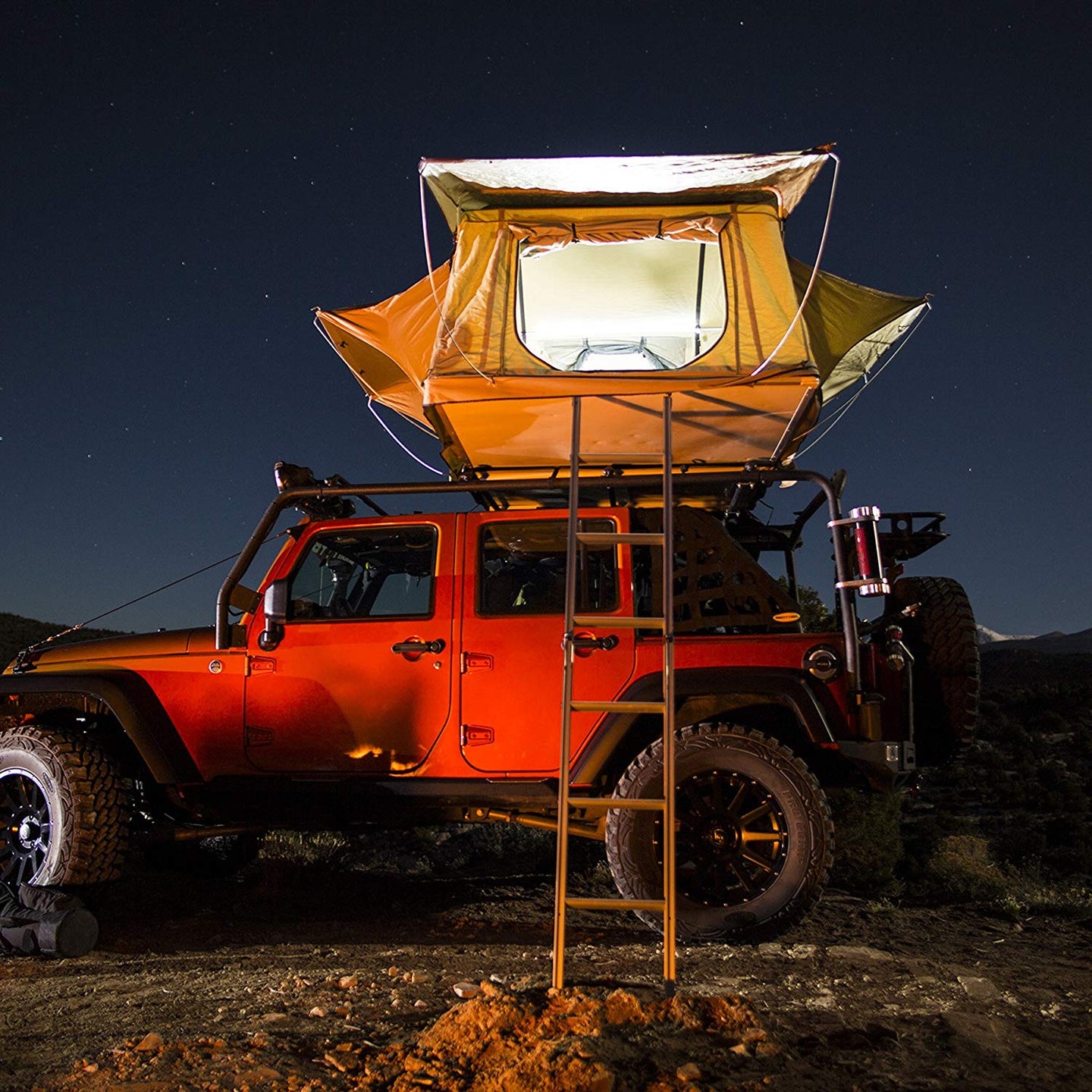 A jeep with a camping tent.