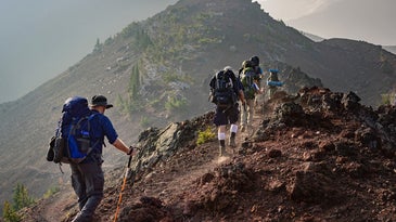 hikers going up a mountain.