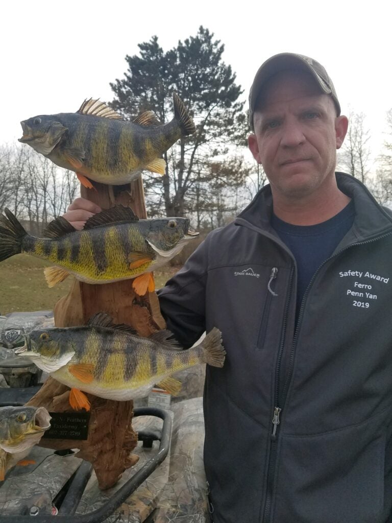 photo of perch fishing expert Dean with a taxidermy display of trophy perch.