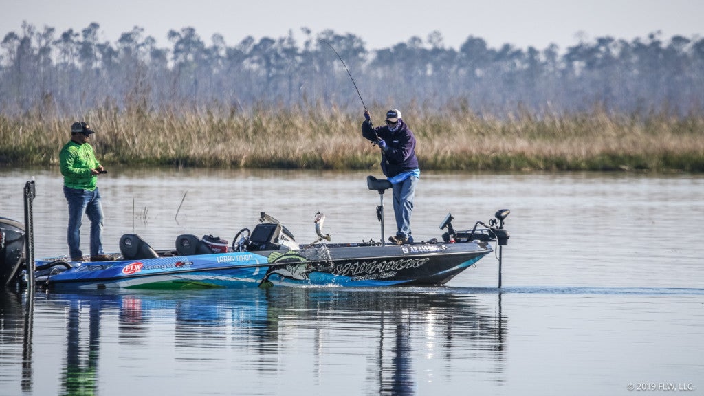 Larry Nixon swings another good bass into the boat while spring bass fishing.