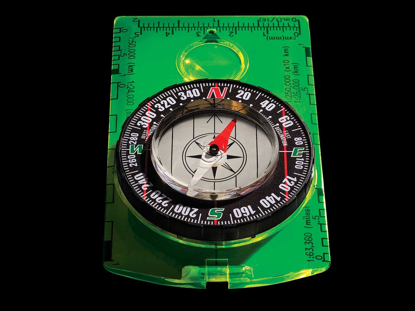 A green compass on a black background.