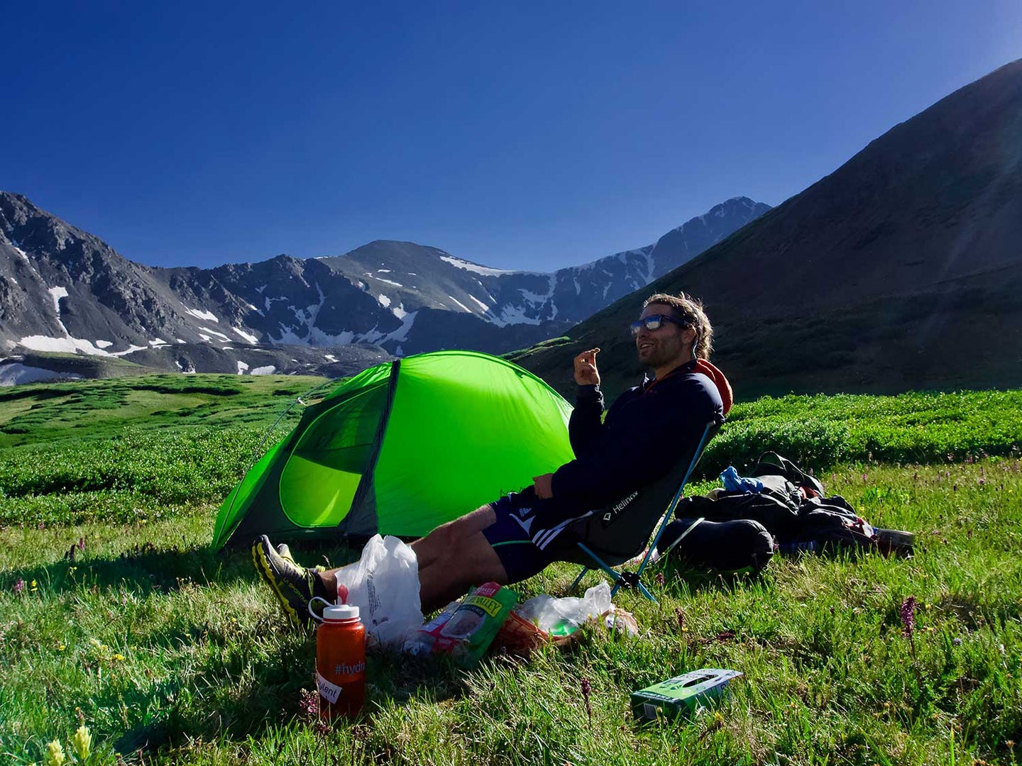 Man eating meal while camping in mountains