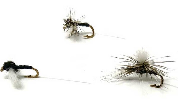 A trio of trico patterned flies on a white background.
