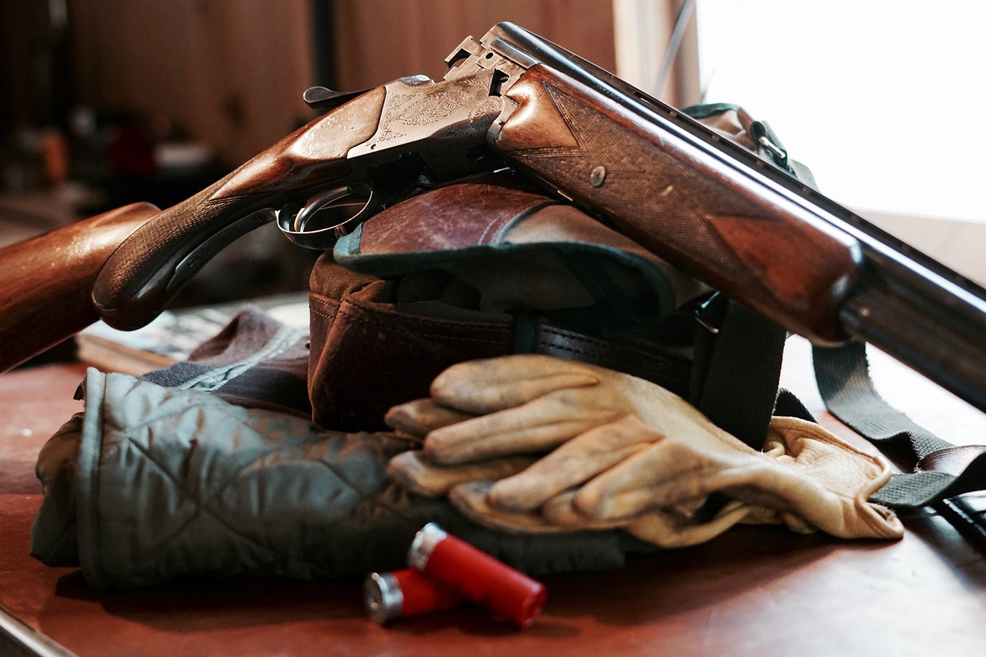 A Browning shotgun and hunting gear on a table.