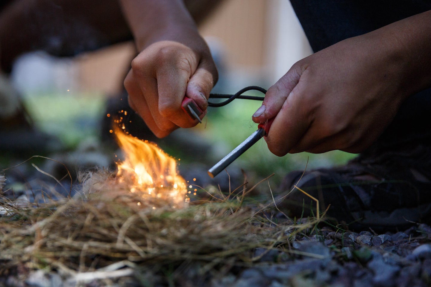 photo of a person making a survival fire