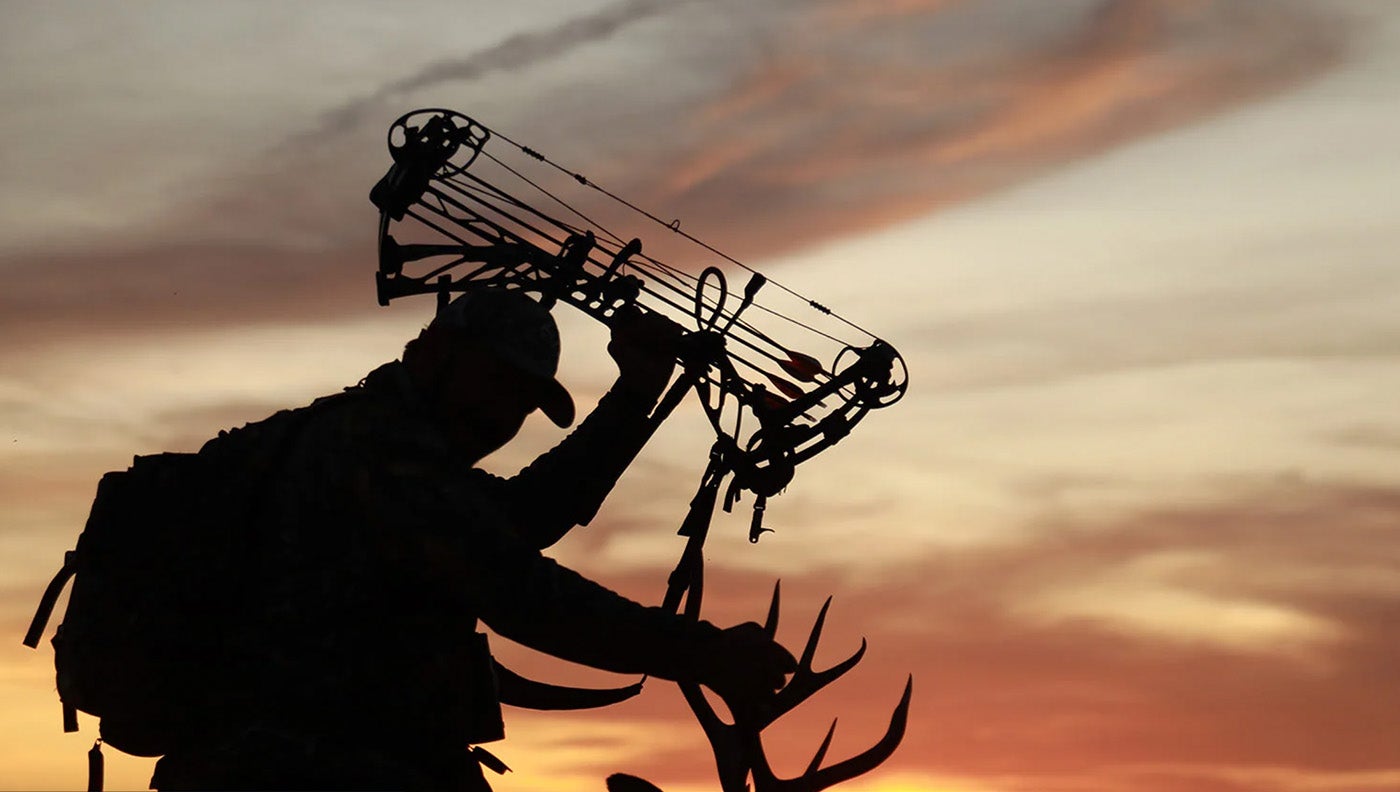 photo of bowhunter with deer