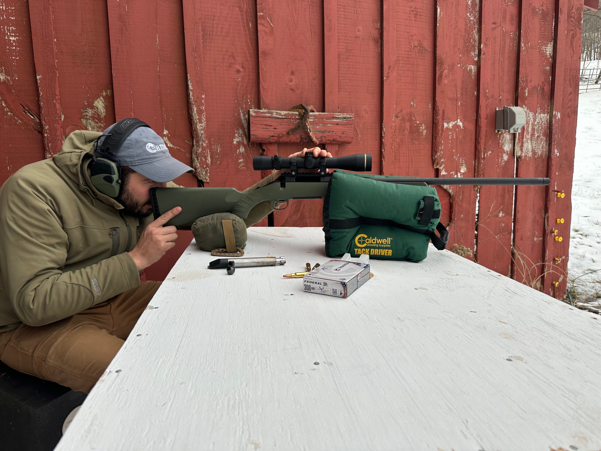 Hunter boresighting a rifle
