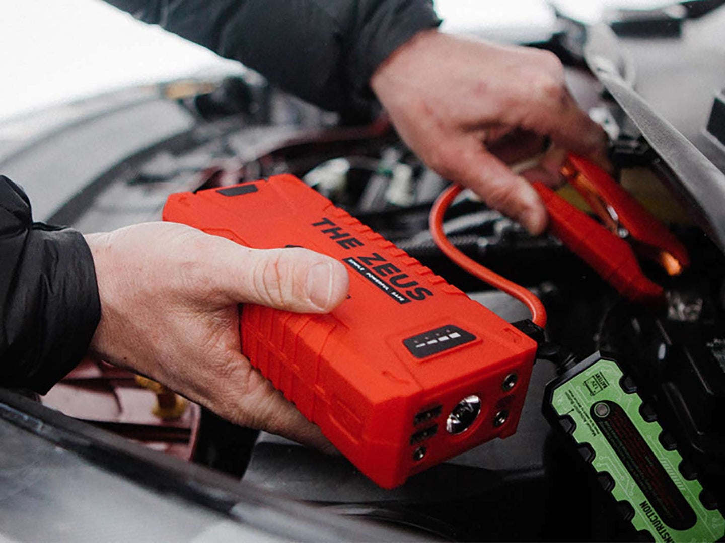 The Zeus Portable Jump Starter hooked to an engine motor.