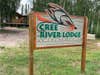 A wooden painted sign with the words: Cree River Lodge at Wapata Lake