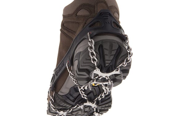 A boot equipped with spikes and chains for grip.