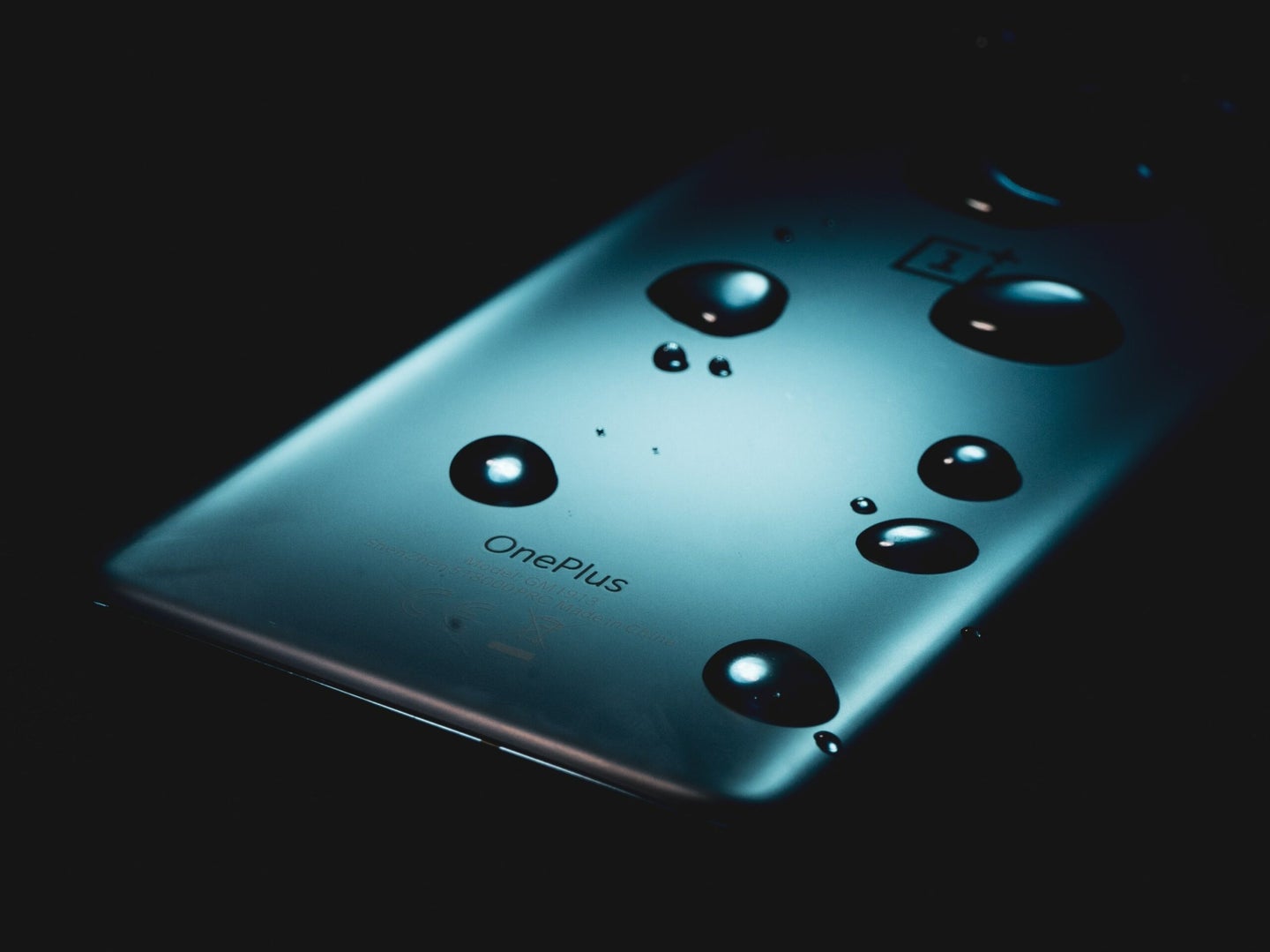 Phone with water droplets in dark