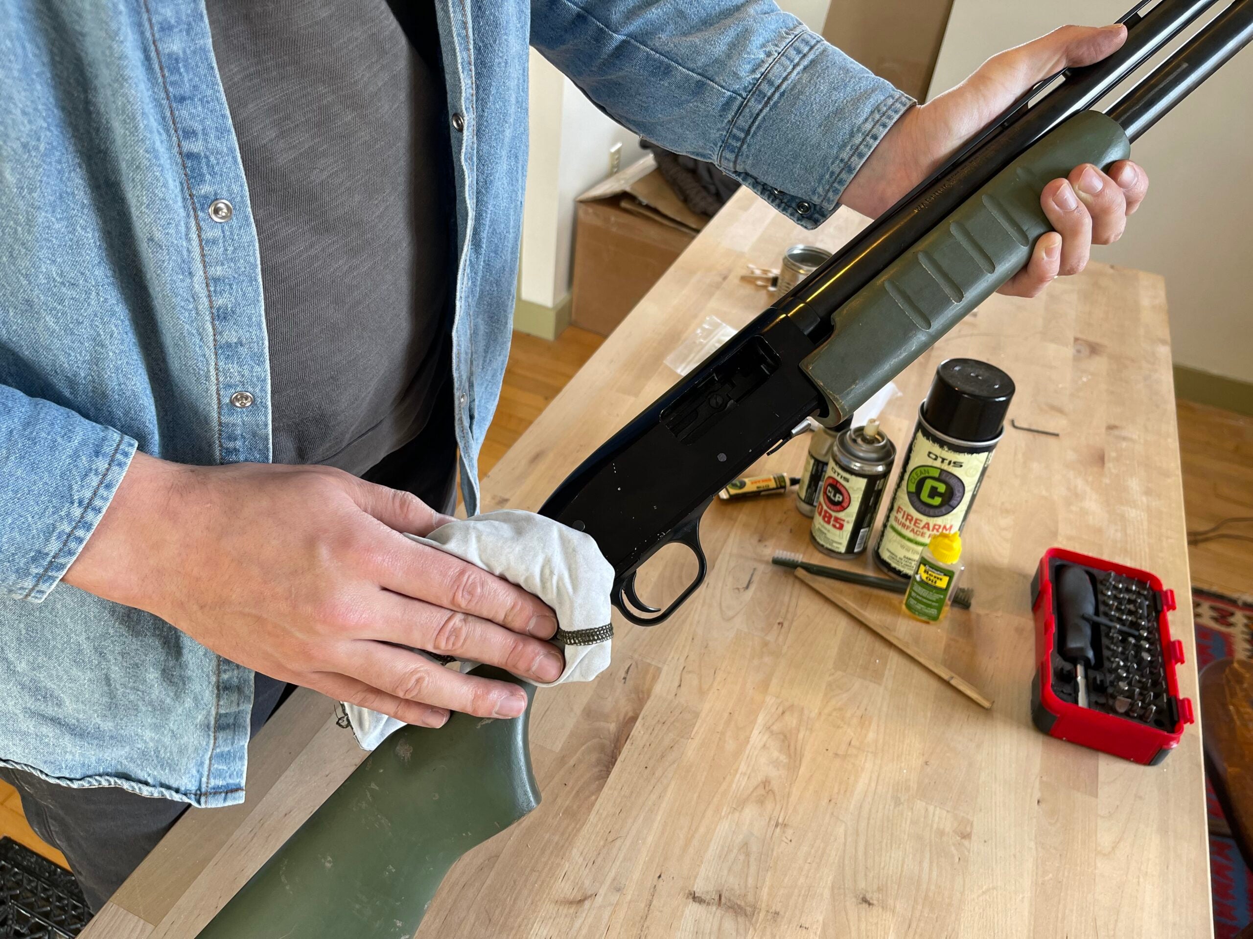 Showing how to clean a shotgun.