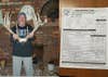 A hunter holds up deer antlers next to a antler score sheet.