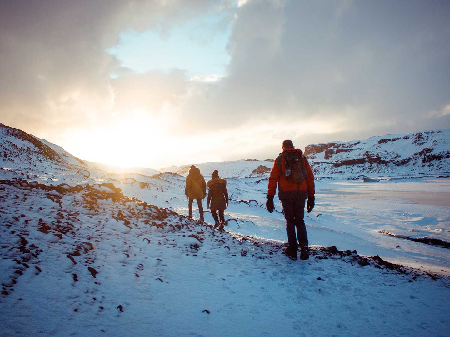People hiking through snowy mountains.