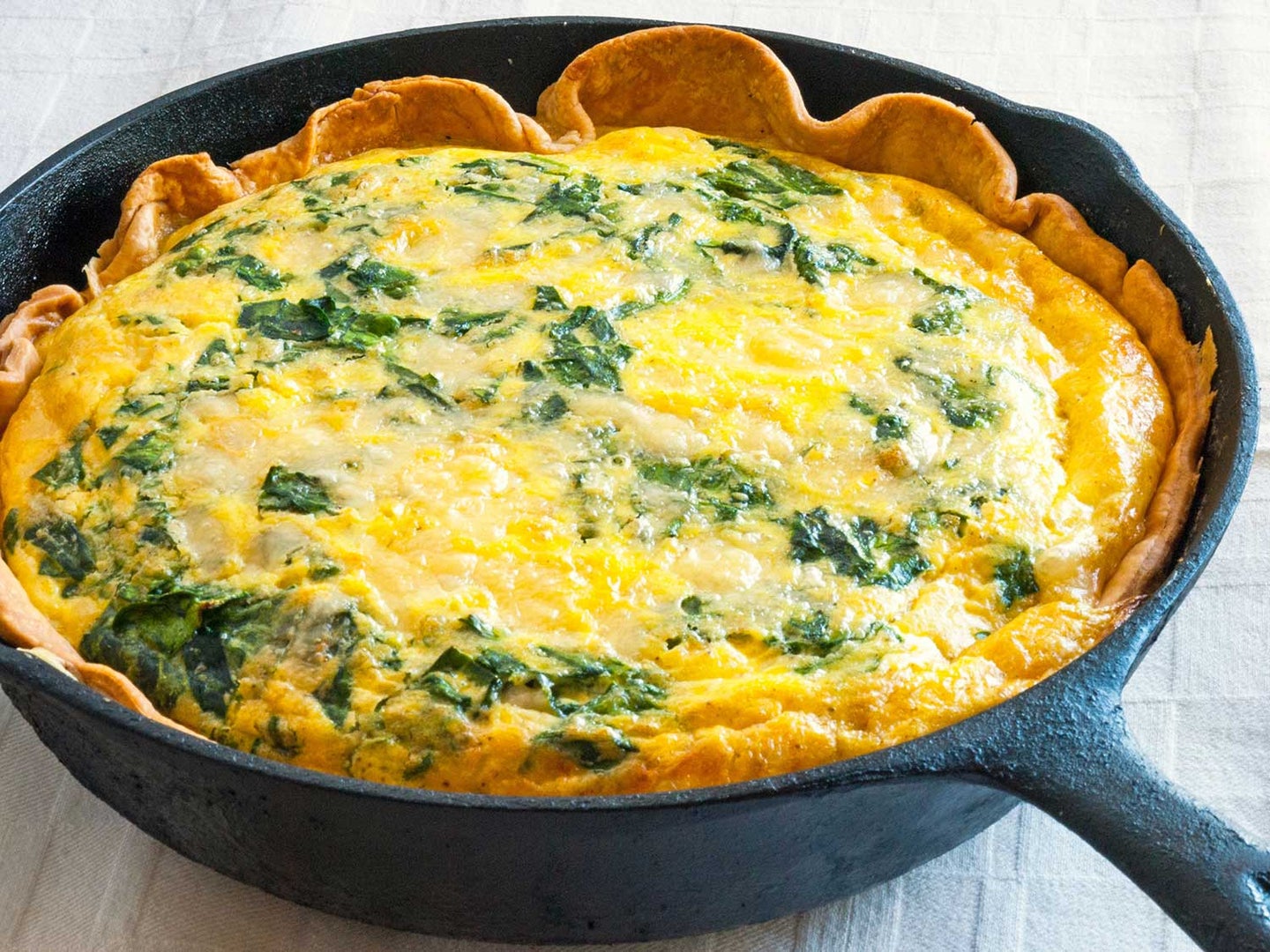 Cast iron skillet with quiche.