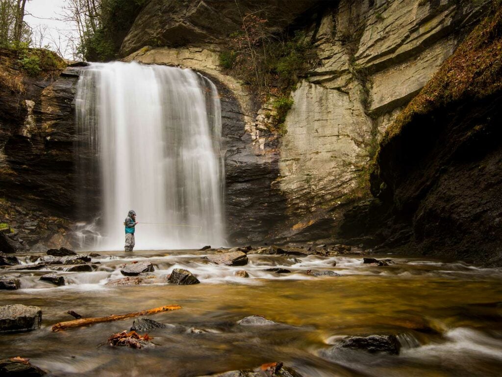 Angler fishing at the Looking Glass Falls in Pisgah National Forest.