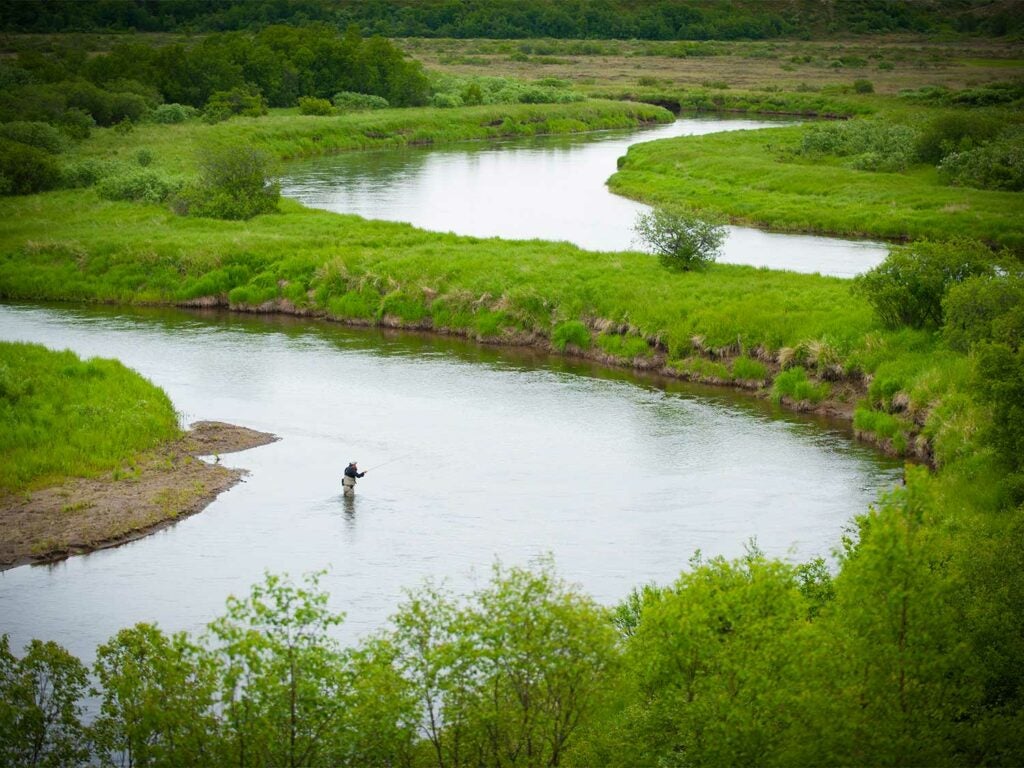 An angler wading through Crystal Creek near King Salmon, Alaska.