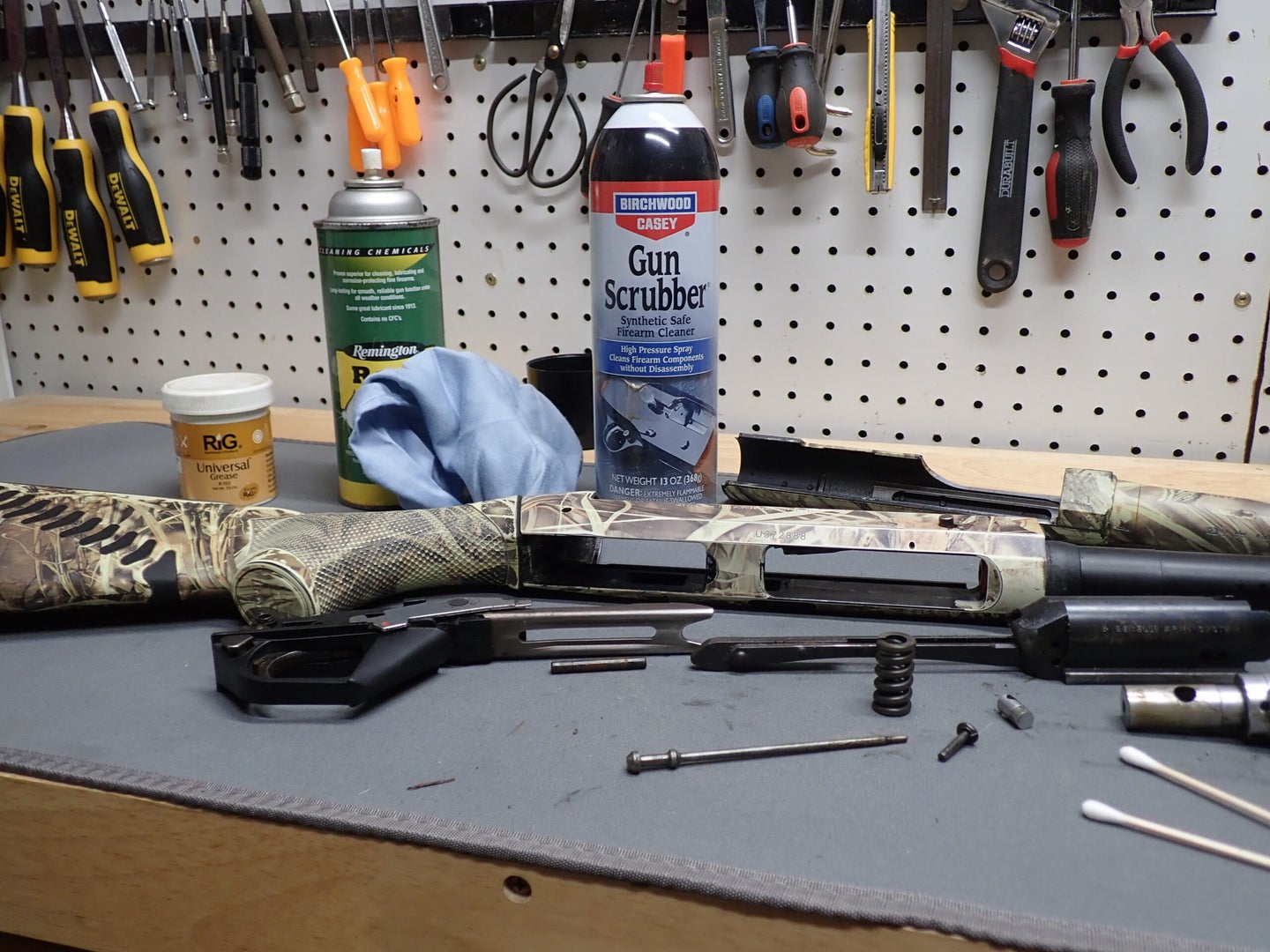 disassembled shotgun on work bench.