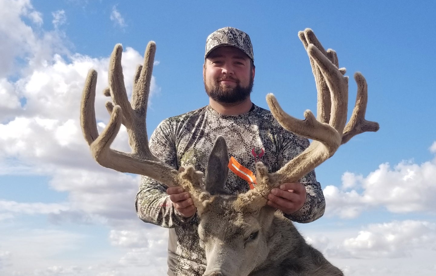 Jordan Phillips and 218-inch mule deer.