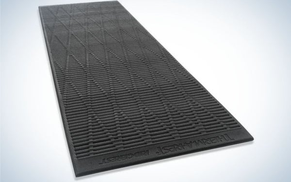a black sleeping pad in a rectangular shape and with a surface designed with small rhombuses.