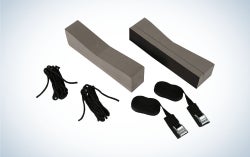 Kayak roof rack including supporting foam blocks, two straps with adjusting buckles, and clips