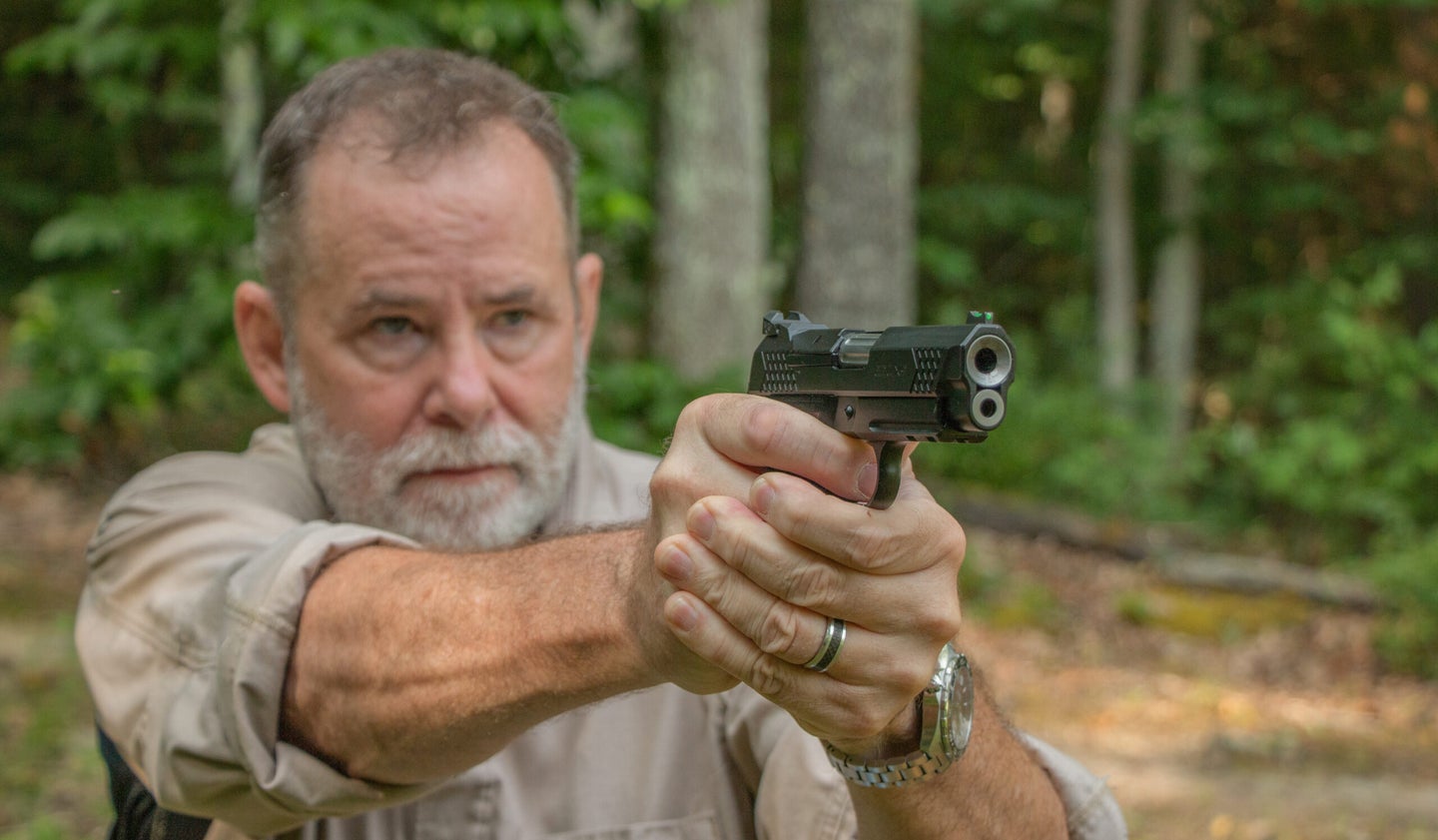 Richard Mann shoots a handgun
