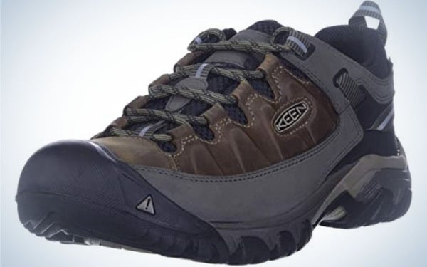 A thick and dark grey and brown men's winter shoes with thick black laces and a dark rubber with the KEEN logo on it.