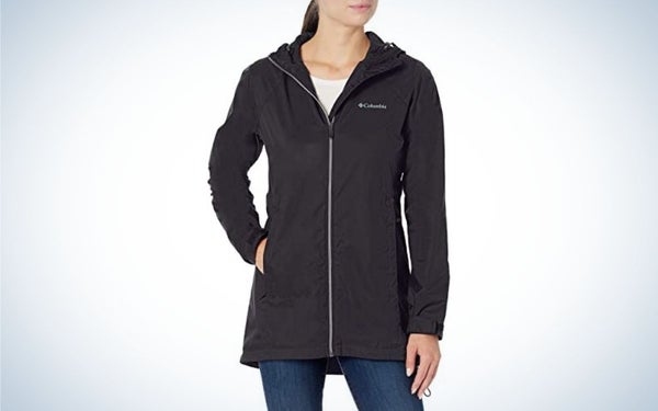 A girl wearing a black windbreakers jacket with a white zipper.