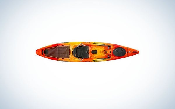 A kayak in an orange in the body and black on the place where you can sit.