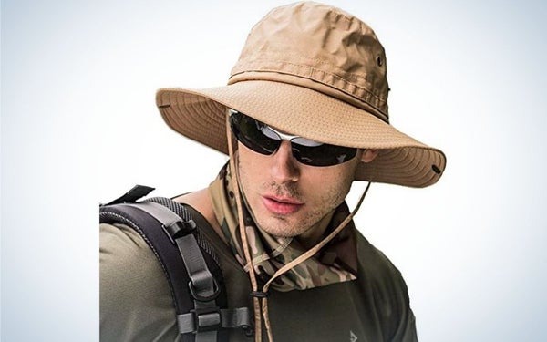 A young man with sunglasses wearing a beige hat.