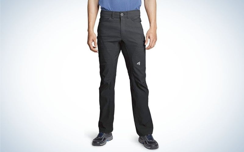 A man wearing trousers with pockets for hiking and blue.
