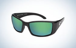 A pair of sunglasses with a black frame and structure and two lenses in bright neon blue.