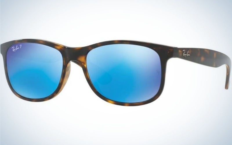A pair of simple glasses with a brown and black skeleton structure and also neon light blue lenses.