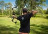 Archer at full draw with a compound bow