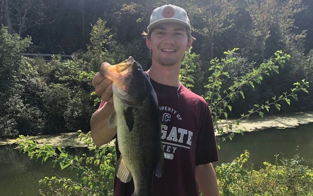 Person holding a big, largemouth fish caught using chatterbait trailers