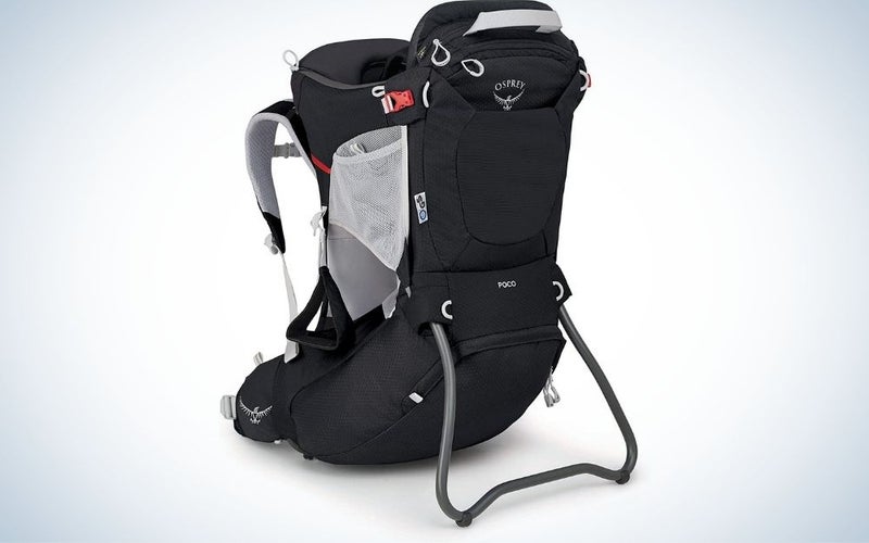 A black backpack with two spacious side pockets with a white net and a space in the middle of the bag that serves as a holder for children.