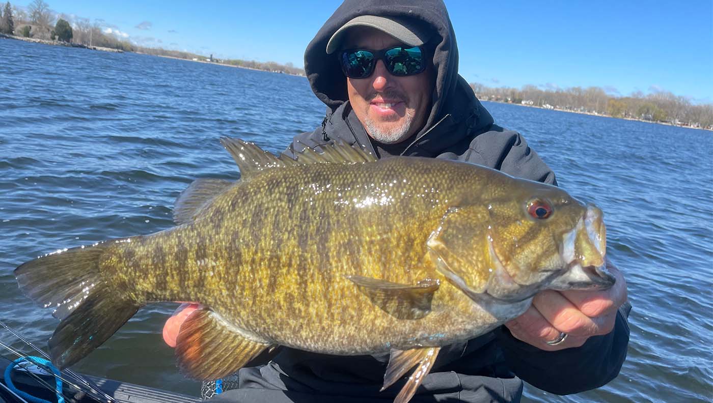 Guide Eric Haataja with a big smallmouth bass.