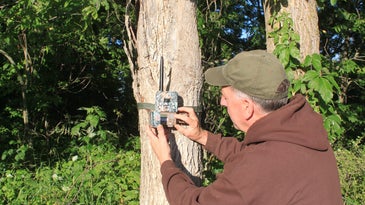 guy setting up trail cam