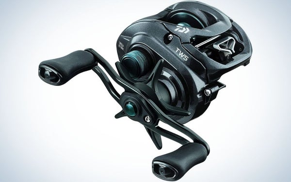 A spincast reel all black as a small intricate machine with two levers moving from the outside.