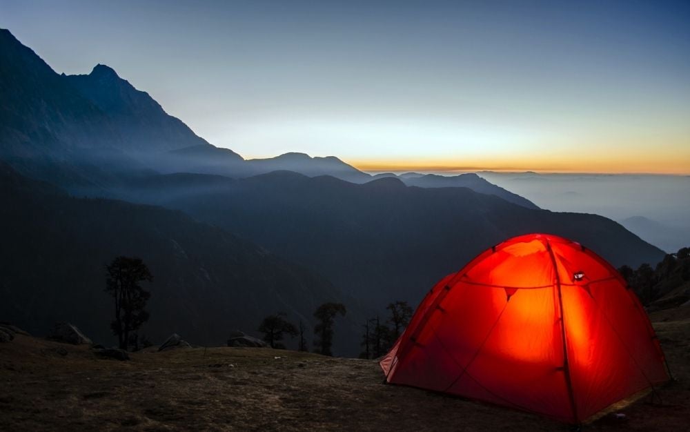 A tent which is light and between the mountains at a high altitude.
